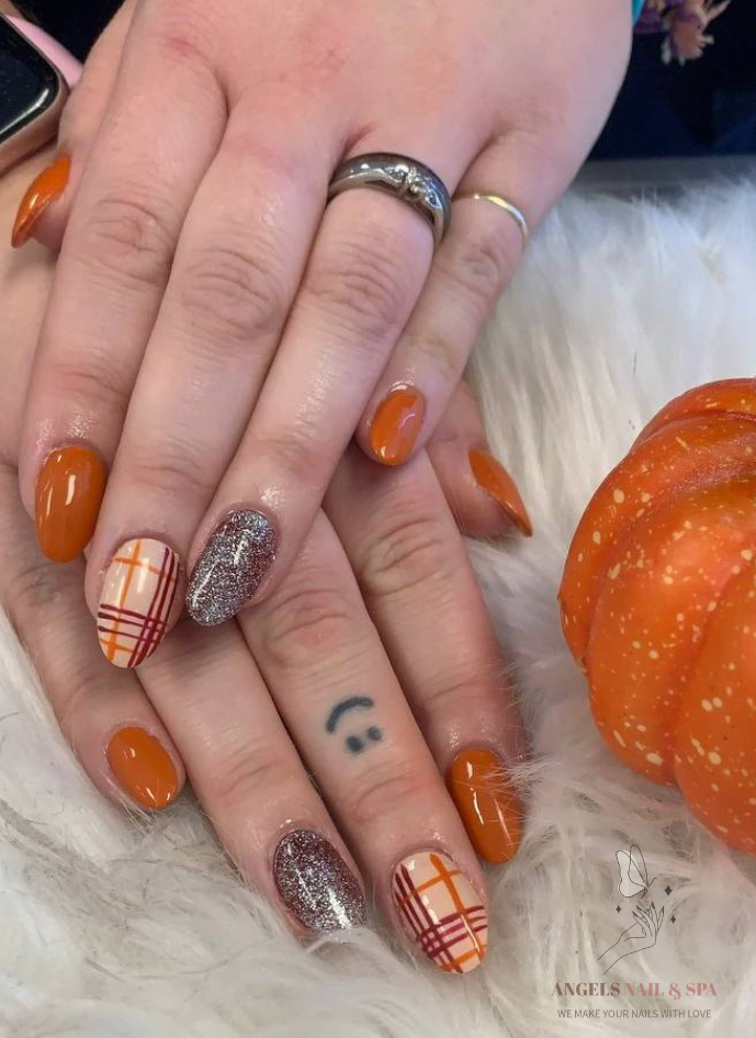 Orange fall nails with plaid design and glitter accent cozy autumn nails Yarmouth nail salon