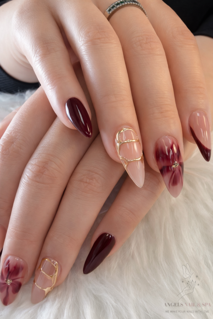 burgundy marble nails in Yarmouth with gold accents at Angels Nail & Spa