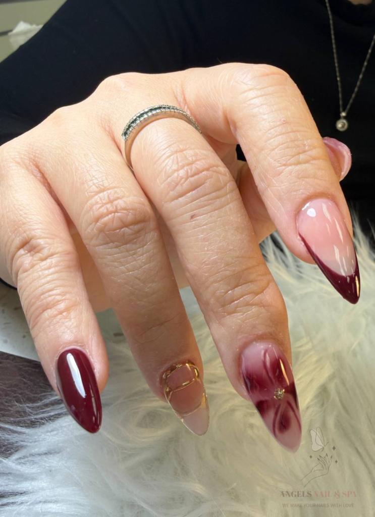 elegant nail design with red marble effect and gold details Yarmouth NS