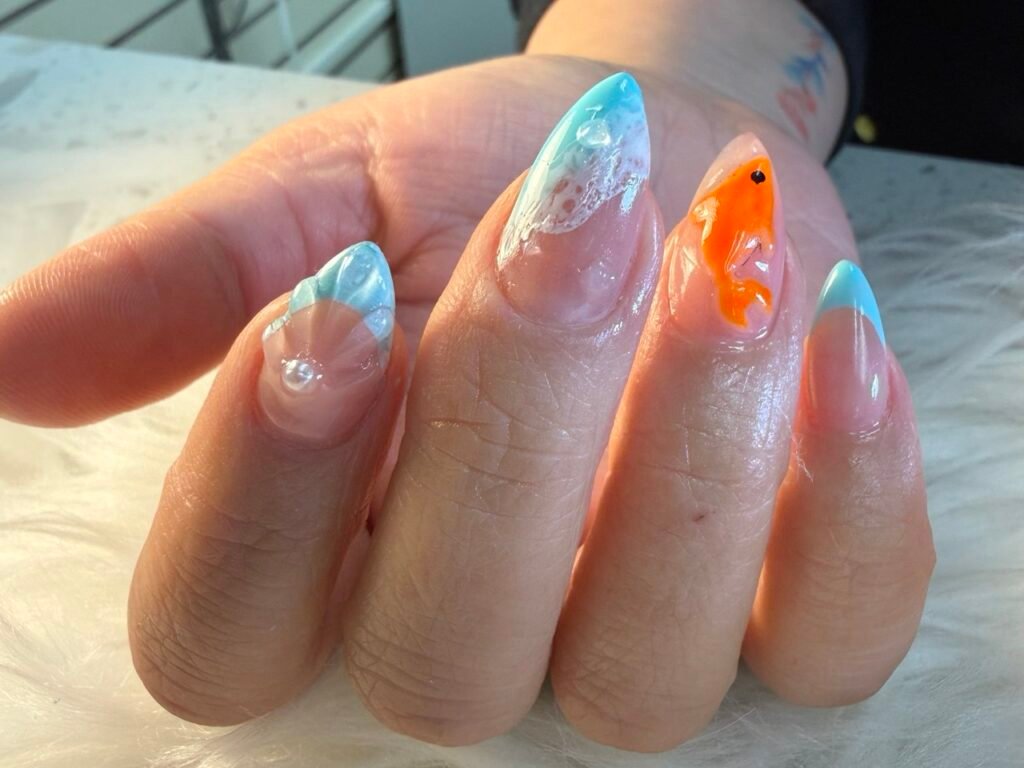beach inspired nails with water effect and fish art at Angels Nail & Spa Yarmouth