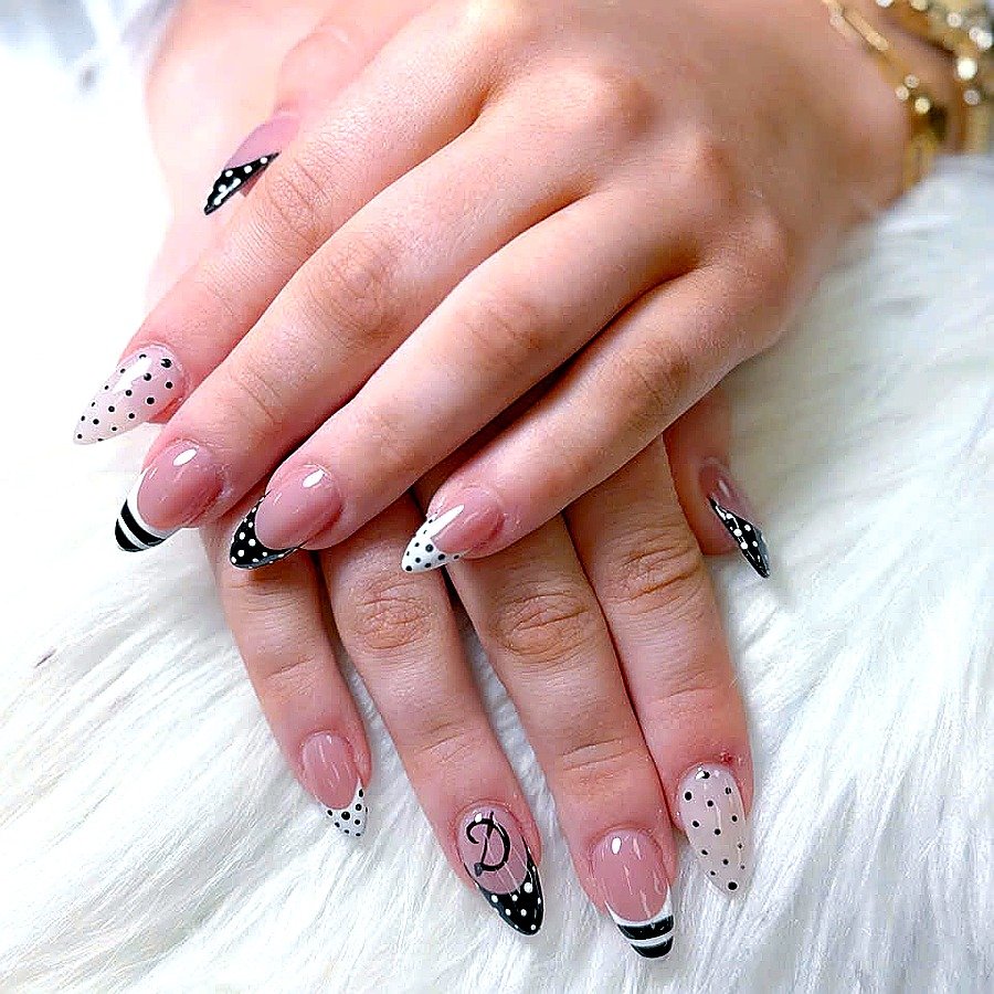 Black white polka dot mixed stiletto nail art by Angels Nail & Spa in Yarmouth NS